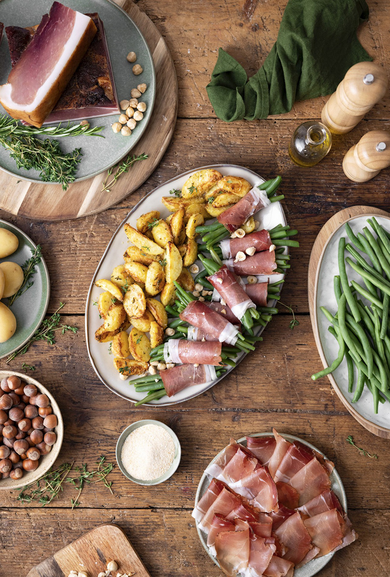 Pommes de terre au four, fagots de haricots, tranches de Speck Alto Adige IGP