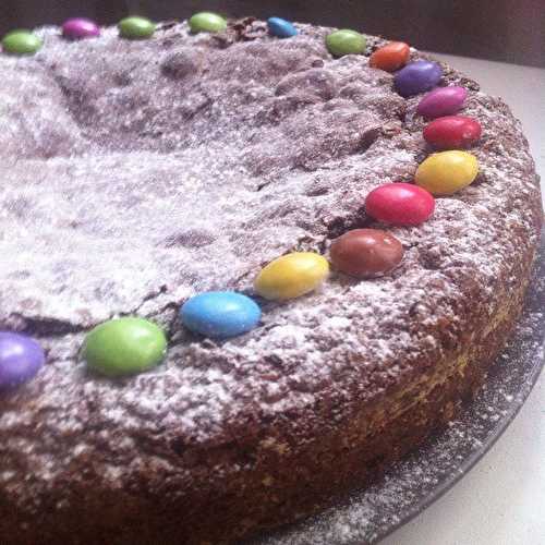 Gâteau au chocolat fèves de cacao et smarties à 4 mains .