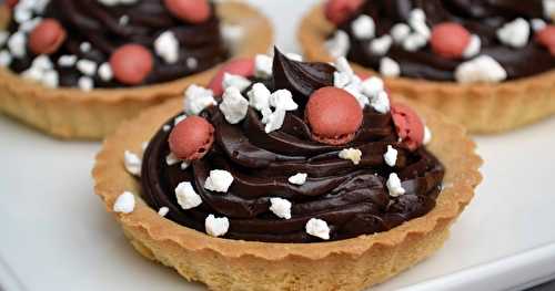 Tartelettes au chocolat noir, crumble de meringue et drops de macarons à la framboise