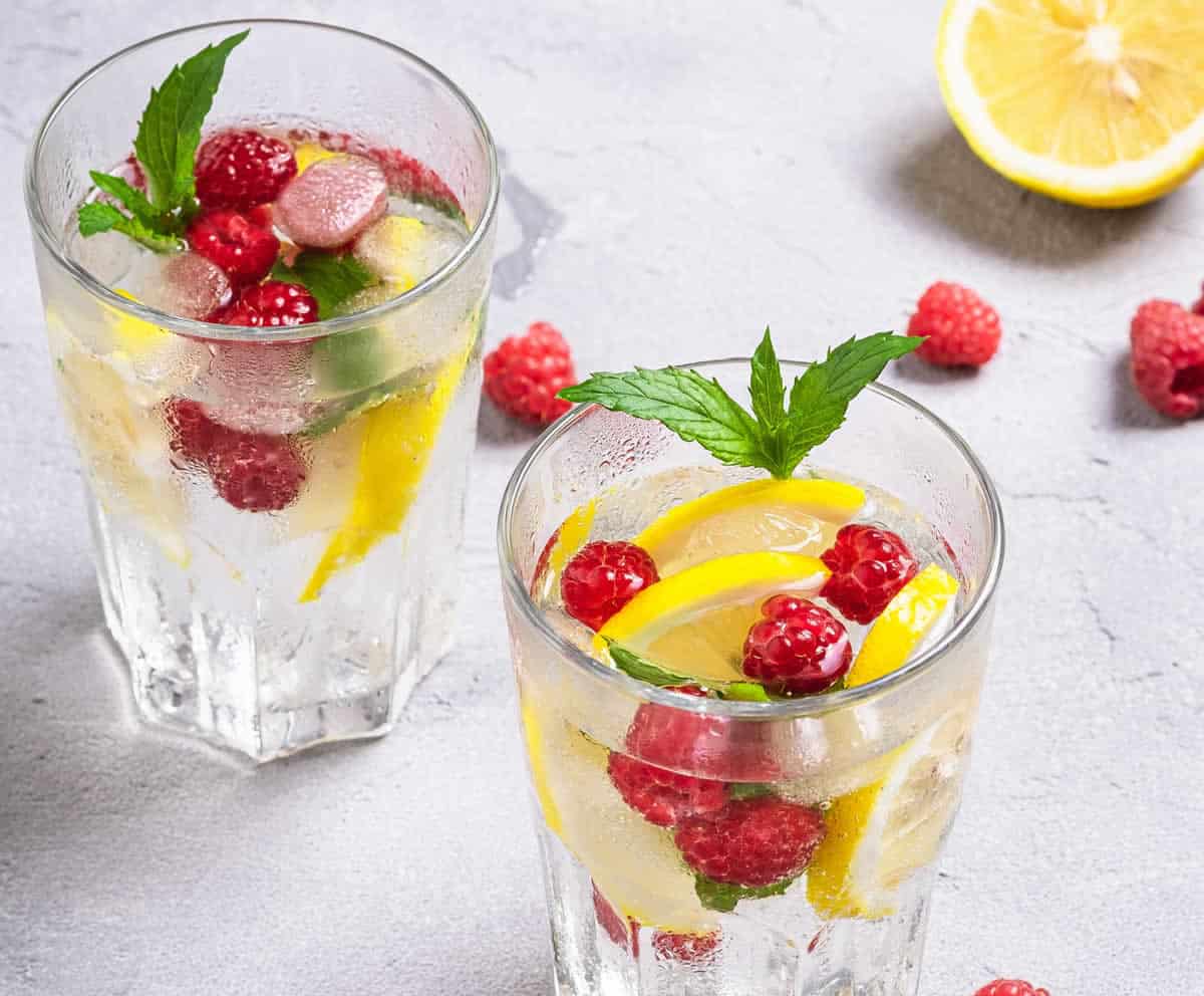 Boisson rafraichissante au citron et framboises : parfaite pour les chaudes journées d'été.